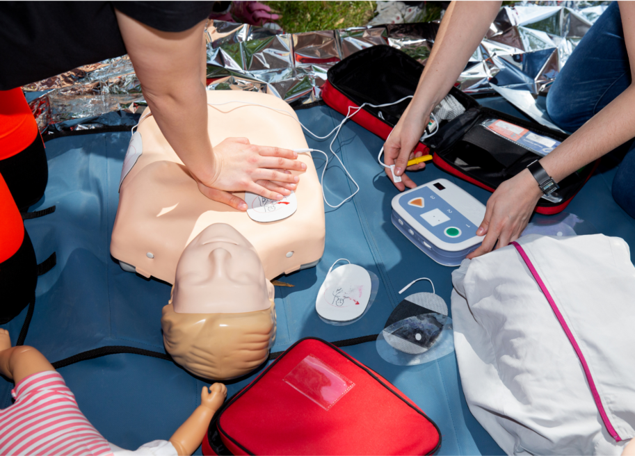 Student demonstrating skills in local NYC cpr and first aid classes with AED usage.